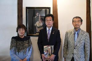 絵画の前で写真を撮る新井藤岡市長と高橋副市長と荒木氏