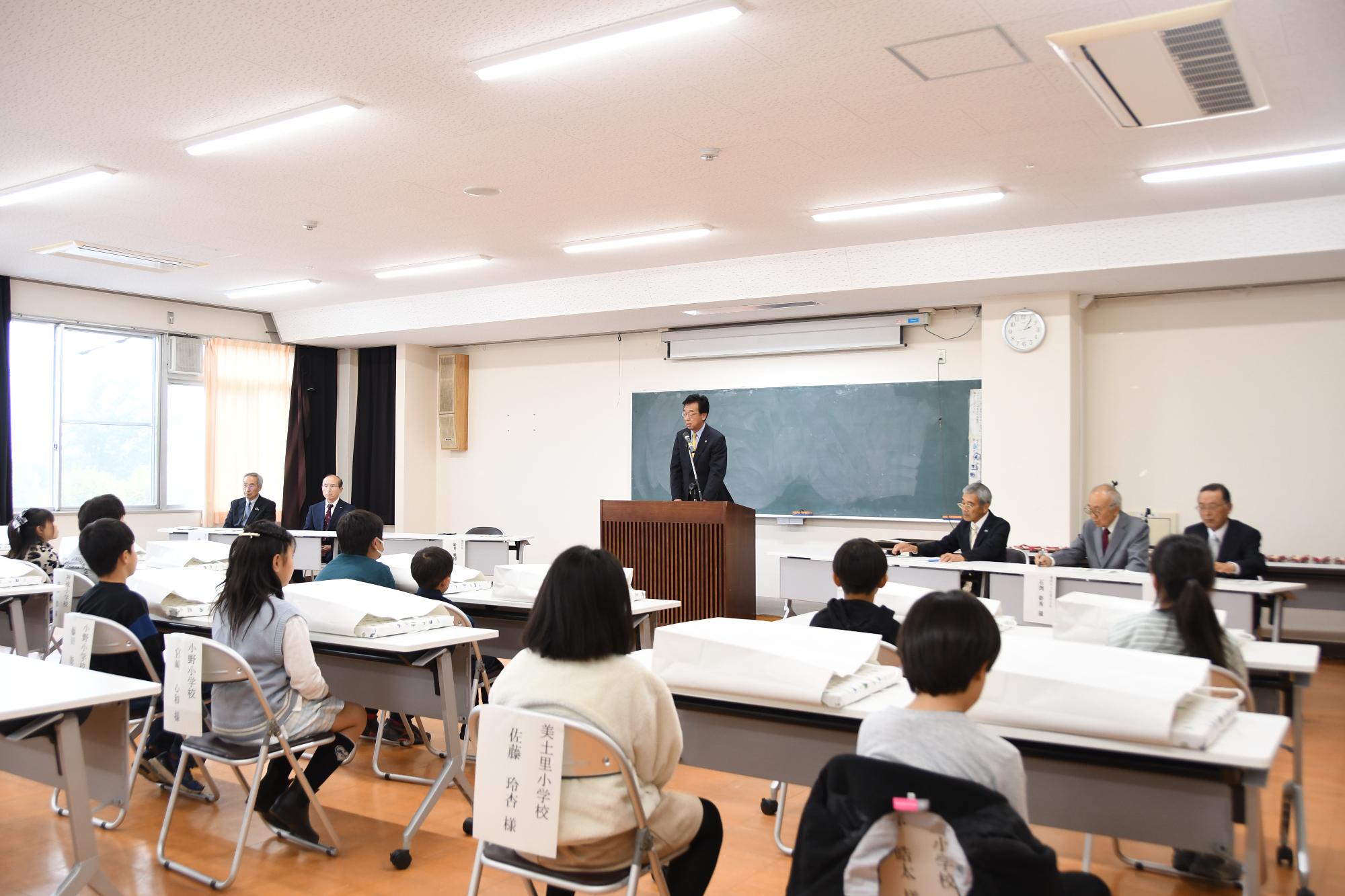 R07高山社とカイコをめぐる絵表彰式で挨拶する新井市長