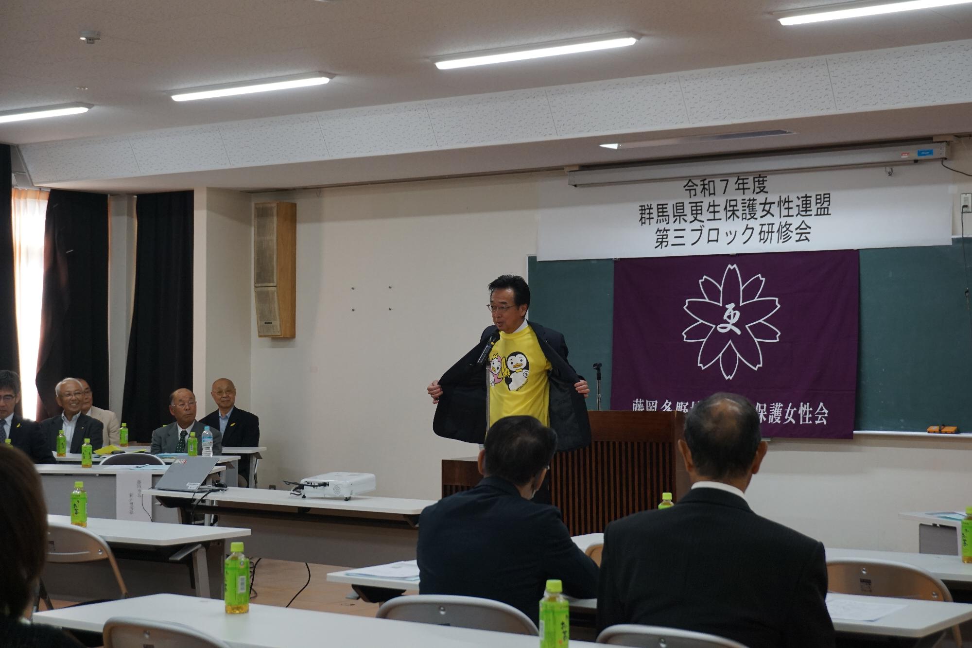 R07更生保護女性連盟第三ブロック研修会でTシャツを着用し挨拶する新井市長